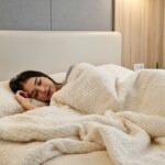 A person sleeping peacefully in a cozy modern bedroom representing effective natural sleep improvement tips for better rest.